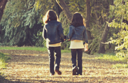 2 girls walking down trail