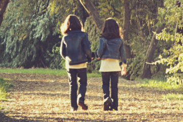 2 girls walking down trail