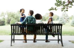 family sitting on bench