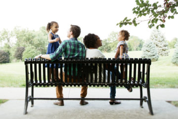 family sitting on bench