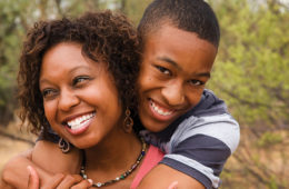 mom and teenage son embracing