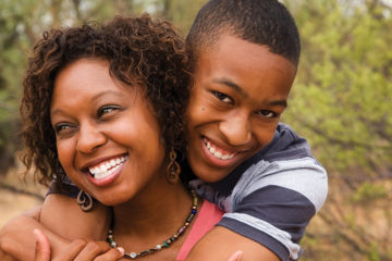 mom and teenage son embracing